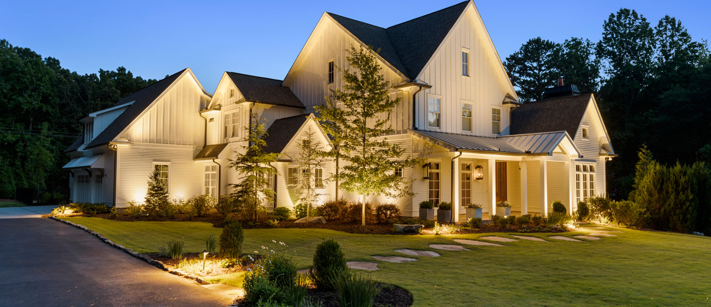 home with custom landscape lighting